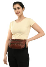 Cognac brown leather waist pouch with brass studs and dual zippers by Dario Lario on neutral backdrop