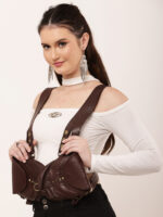 Model wearing brown double leather shoulder harness bag with twin pouches and brass studs