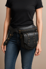 Structured black leather waist pouch with riveted front panel and zipper compartments – Dario Lario