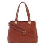 Blue croc-embossed leather handbag with double handles, placed in soft natural light with flowers nearby — a premium, handcrafted accessory by Dario Lario.