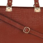 Blue croc-embossed leather handbag with double handles, placed in soft natural light with flowers nearby — a premium, handcrafted accessory by Dario Lario.