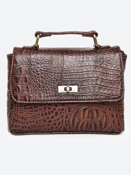 “Brown croc-textured leather sling bag with top handle and twist-lock closure.”