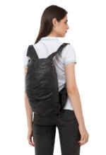 “Black leather travel bag worn over the shoulder by a model, featuring a soft structured design and zip compartments.”